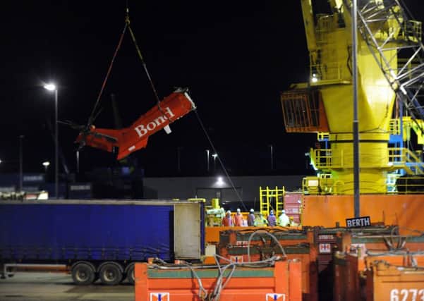 The wreckage of a helicopter tail that ditched in the North Sea is brought to Aberdeen Harbour. Picture: Newsline