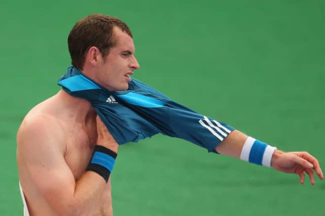 Andy Murray changes his shirt during his match against Lleyton Hewitt at the AAMI Classic at Kooyong. Picture: Getty
