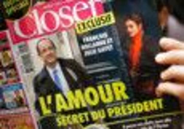 A man reads Closer's story on President Francois Hollande and actress Julie Gayet. Picture: Getty
