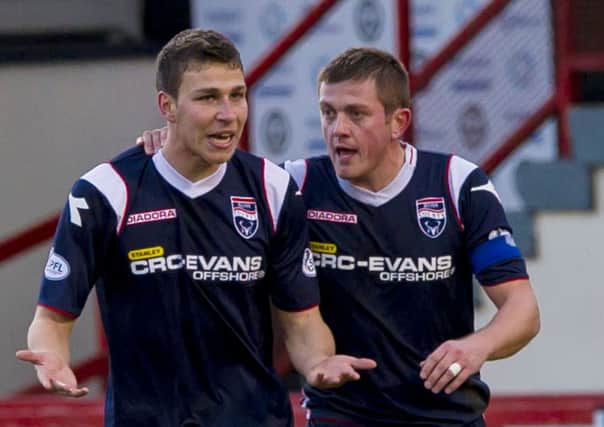 Filip Kiss, left, is congratulated by Richie Brittain after scoring twice on his debut to earn Ross County a point at Firhill. Picture: SNS