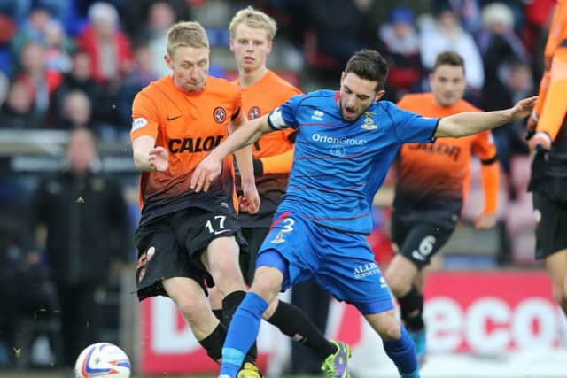 Inverness Caledonian Thistle's Graeme Shinnie takes on Dundee United's Chris Erskine. Picture: PA