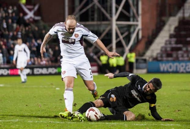 Motherwells Keith Lasley, top, tackles Jamie Hamill. Picture: SNS