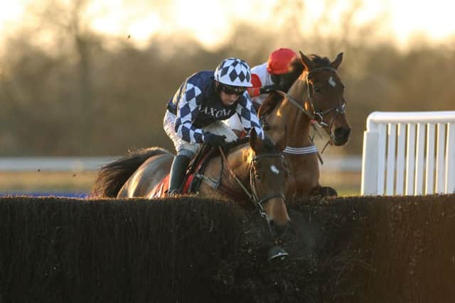 Shotgun Paddy, left, ridden by Leighton Aspell ploughs through the last fence. Picture: PA