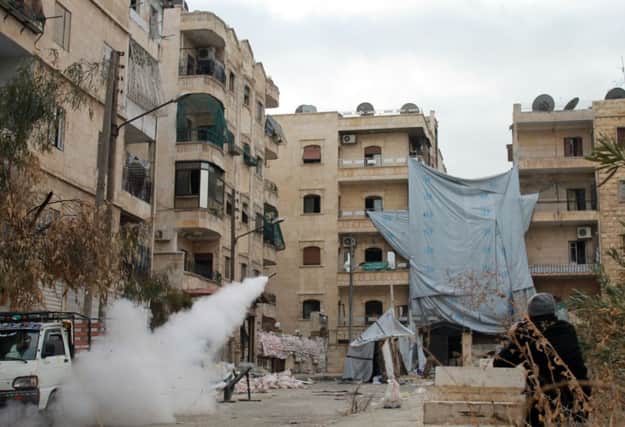 Opposition fighters fire a rocket towards Assad troops in Aleppo. Picture: Getty