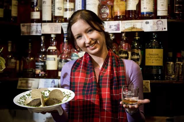 Waitress Aurelija Cepkauskaite at the Rabbie Burns Cafe on Edinburgh's Royal Mile tucks into some haggis, neeps and tatties. Picture: Ian Georgeson