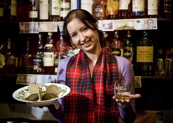 Waitress Aurelija Cepkauskaite at the Rabbie Burns Cafe on Edinburgh's Royal Mile tucks into some haggis, neeps and tatties. Picture: Ian Georgeson