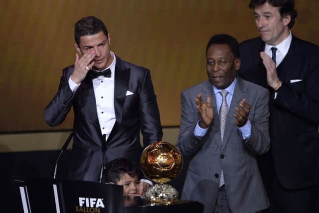 Ronaldo, left, cries as he is presented witht he Ballon d'Or. Picture: Getty