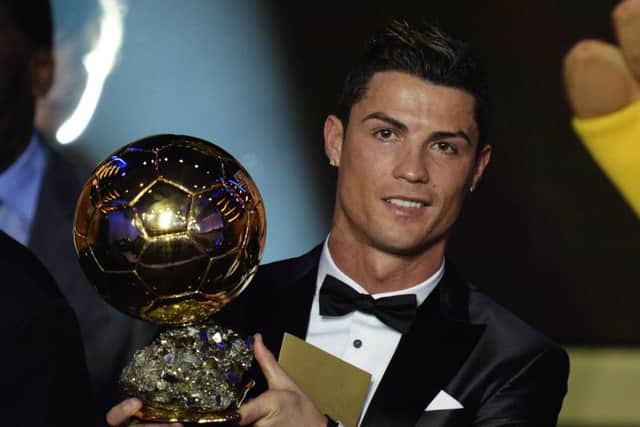 Cristiano Ronaldo holds the 2013 Ballon d'Or aloft. Picture: AP