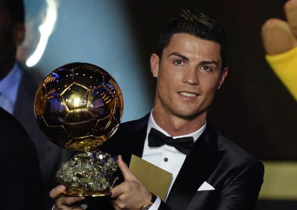 Cristiano Ronaldo holds the 2013 Ballon d'Or aloft. Picture: AP