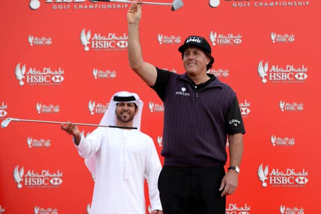 Phil Mickelson larks about with dancers during a photo call prior to the start of the Abu Dhabi HSBC Golf Championship. Picture: Getty