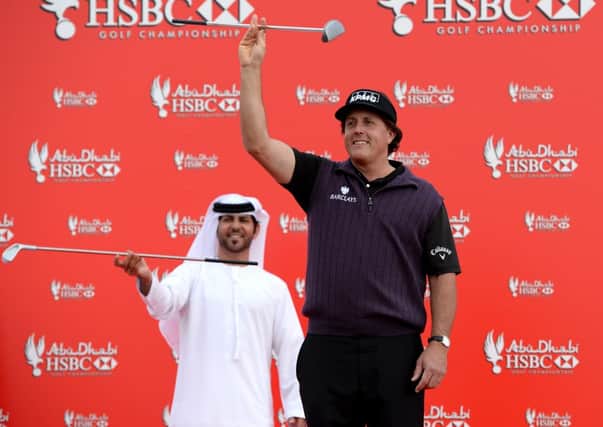 Phil Mickelson larks about with dancers during a photo call prior to the start of the Abu Dhabi HSBC Golf Championship. Picture: Getty