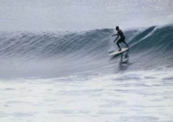 A surfer at Arugam Bay, Sri Lanka, in 1998, when the  area was outside the government declared safe zone
