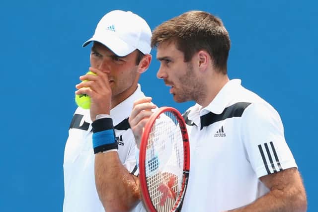 Ross Hutchins, left, and Colin Fleming win their first match since Hutchins cancer recovery. Picture: Getty