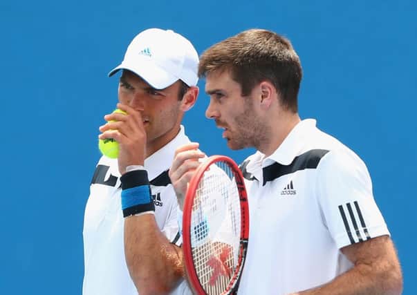 Ross Hutchins, left, and Colin Fleming win their first match since Hutchins cancer recovery. Picture: Getty
