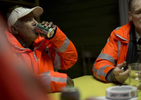 Three street cleaners head out to work to earn their beer, tobacco and lunch in the east of Amsterdam. Picture: AP