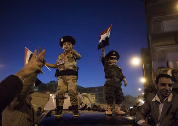 Supporters of General Abdel Fattah al-Sisi celebrate at the end of the voting in Cairos Shubra district. Picture: Getty