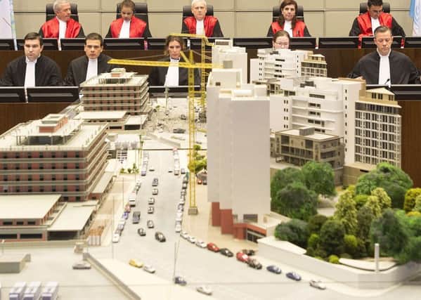 Judges behind the model of Beirut showing where statesman Rafik al-Hariri was killed by a car bomb. Picture: Reuters
