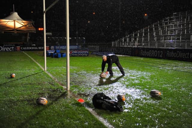 Staff collect practice gear after the Glasgow v Edinburgh new year game was postponed. Picture: Robert Perry