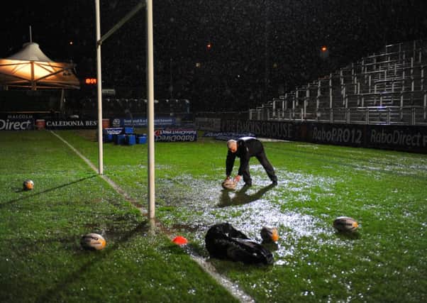 Staff collect practice gear after the Glasgow v Edinburgh new year game was postponed. Picture: Robert Perry