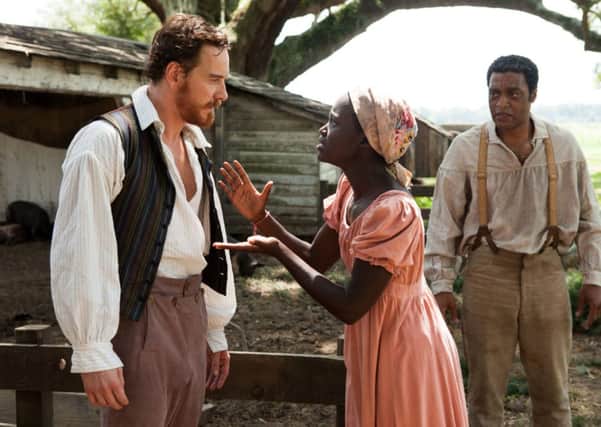 Michael Fassbender, left, Lupita Nyong'o and Chiwetel Ejiofor, right, in 12 Years A Slave. Picture: AP