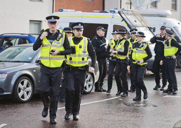 Police officers search the Ferry Gait Crescent neighborhood of Mikaeel Kular yesterday. Picture: Getty