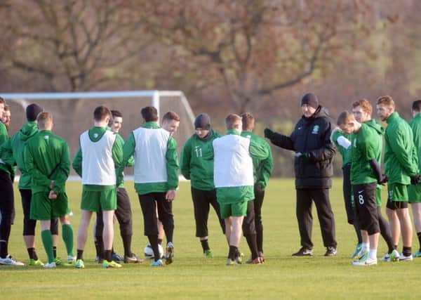 Hibernian manager Terry Butcher directs his players at a training session yesterday. Picture: Phil Wilkinson