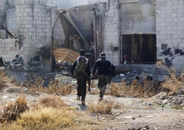 Free Syrian Army fighters run for cover near Damascus. Picture: Reuters