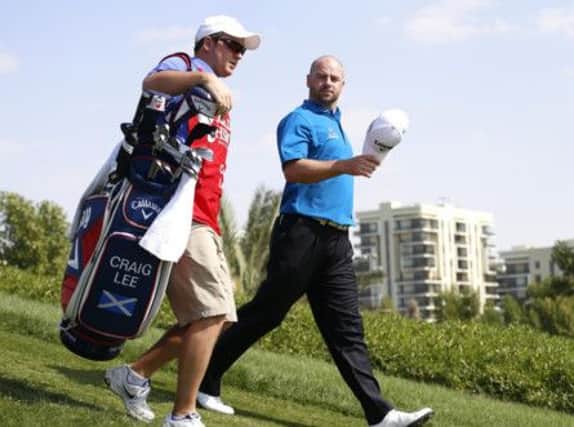 Craig Lee walks chats with his caddie during yesterdays third round in Abu Dhabi. Picture: Reuters
