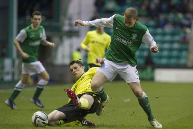 St Mirren's John McGinn slides in on Scott Robertson (right). Picture: SNS