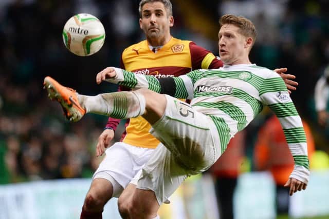 Celtic's Kris Commons (right) holds off Keith Lasley. Picture: SNS