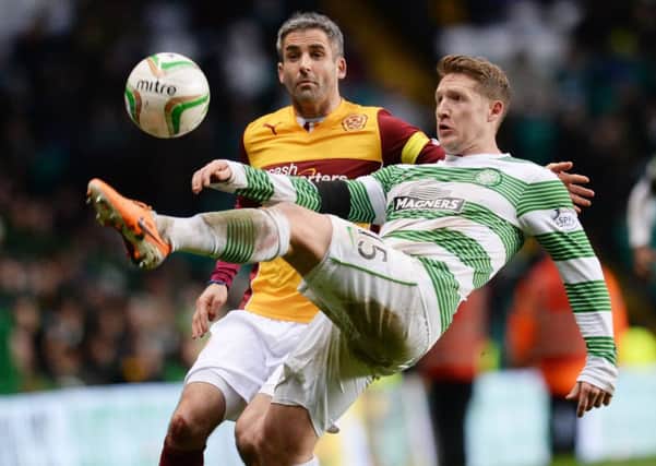 Celtic's Kris Commons (right) holds off Keith Lasley. Picture: SNS