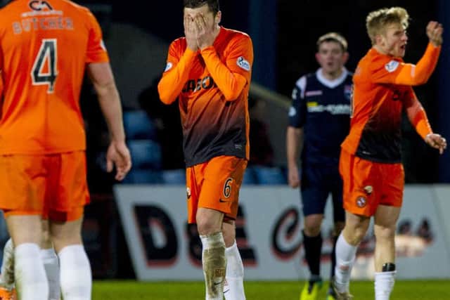 Paul Paton (centre) hangs his head as Dundee Utd suffer a 3-0 defeat to Ross County. Picture: SNS