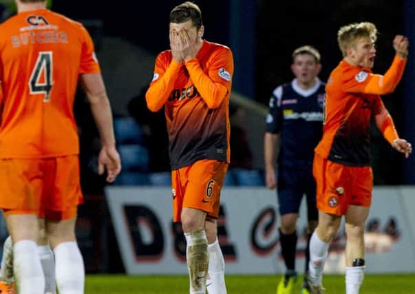 Paul Paton (centre) hangs his head as Dundee Utd suffer a 3-0 defeat to Ross County. Picture: SNS