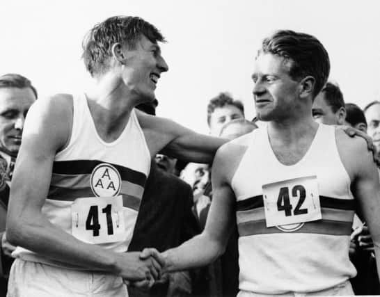 Chris Chataway, right, and Roger Bannister celebrate the latters mile in less than four minutes. Picture: AP