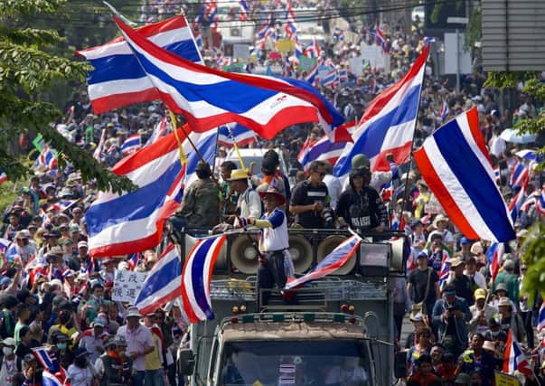 Antigovernment protesters undertake a colourful procession through Bangkok yesterday. Picture: Getty