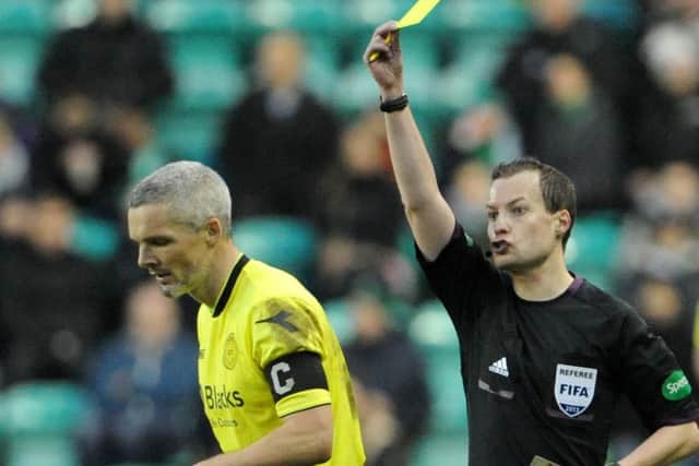 Referee Willie Collum shows St Mirrens Jim Goodwin the yellow card at Easter Road. Picture: Jane Barlow