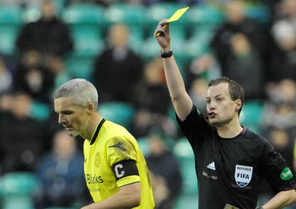 Referee Willie Collum shows St Mirrens Jim Goodwin the yellow card at Easter Road. Picture: Jane Barlow