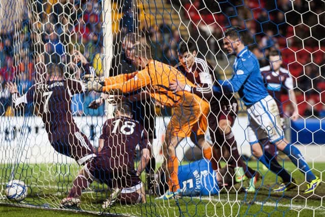 Alan Mannus shoves Ryan Stevenson into the back of the net. Picture: Ian Georgeson