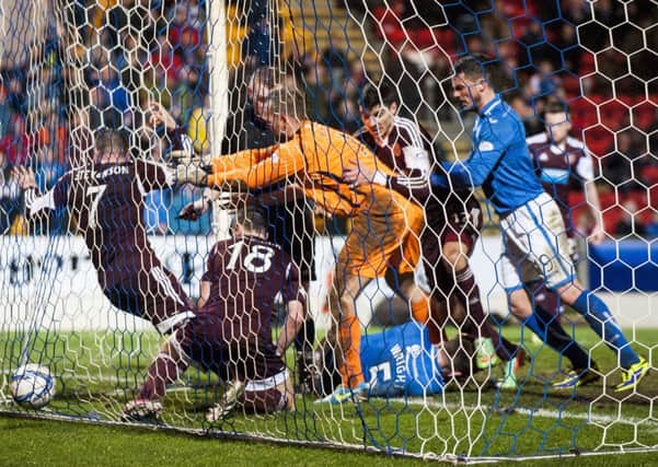 Alan Mannus shoves Ryan Stevenson into the back of the net. Picture: Ian Georgeson
