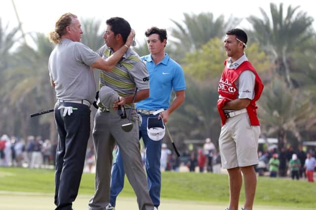 Miguel Angel Jimenez, left, congratulates fellow Spaniard Pablo Larrazabal. Picture: Reuters