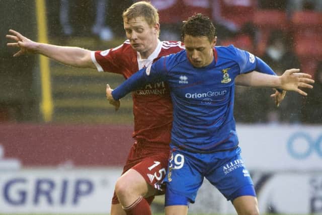 Inverness goalscorer Danny Williams tangles with Aberdeens Barry Robson. Picture: SNS