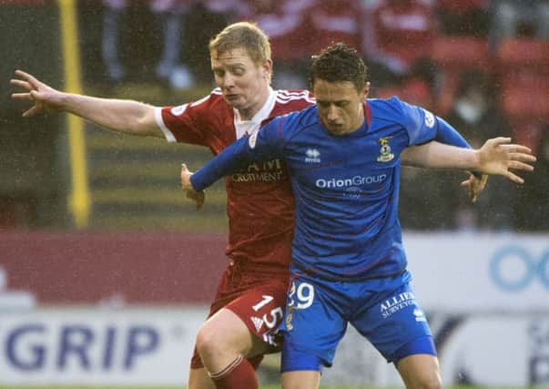 Inverness goalscorer Danny Williams tangles with Aberdeens Barry Robson. Picture: SNS