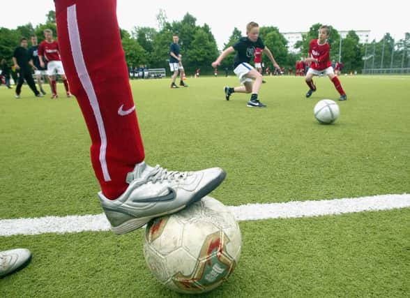 Homework for parents: Make sure to take kids out so they can play football. Picture: Getty