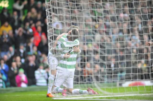 Kris Commons celebrates his first goal with Charlie Mulgrew. Picture: Robert Perry