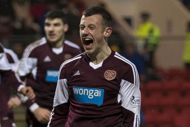 Dale Carrick celebrates after pulling one back for Hearts. Picture: SNS