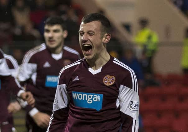 Dale Carrick celebrates after pulling one back for Hearts. Picture: SNS
