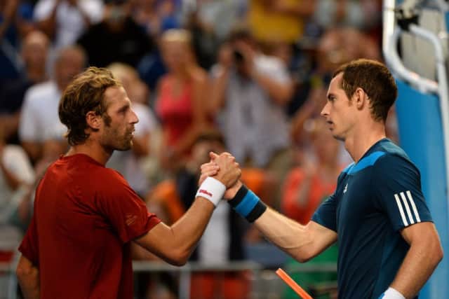 Andy Murray shakes hands with Stephane Robert after winning their men's singles match. Picture: Getty
