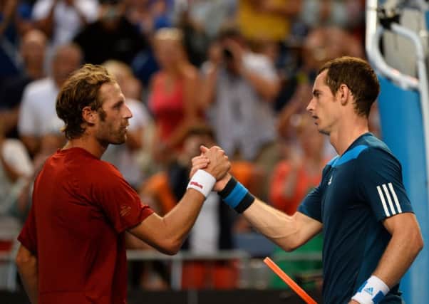Andy Murray shakes hands with Stephane Robert after winning their men's singles match. Picture: Getty