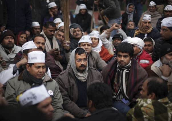 Surrounded by his supporters, Arvind Kejriwal does not dress like a typical first minister. Picture: AP