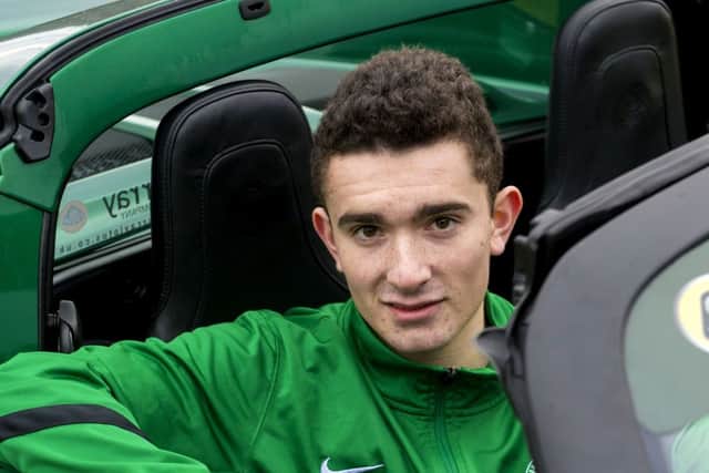 Alex Harris gets behind the wheel of a promotional Lotus after signing his new contract. Picture: SNS